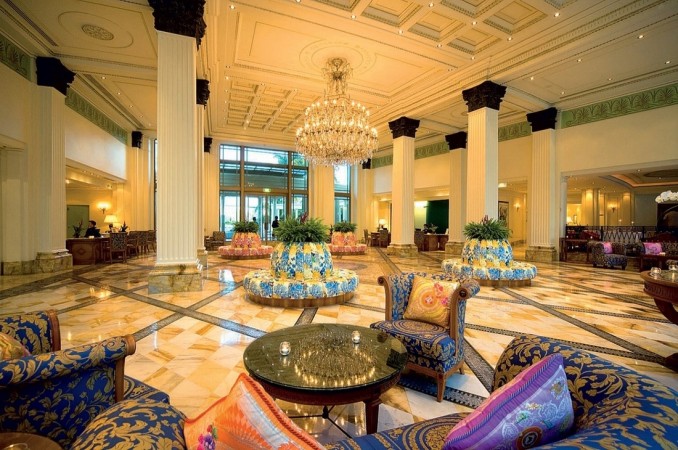 A large hotel lobby featuring a chandelier showcases interior design.