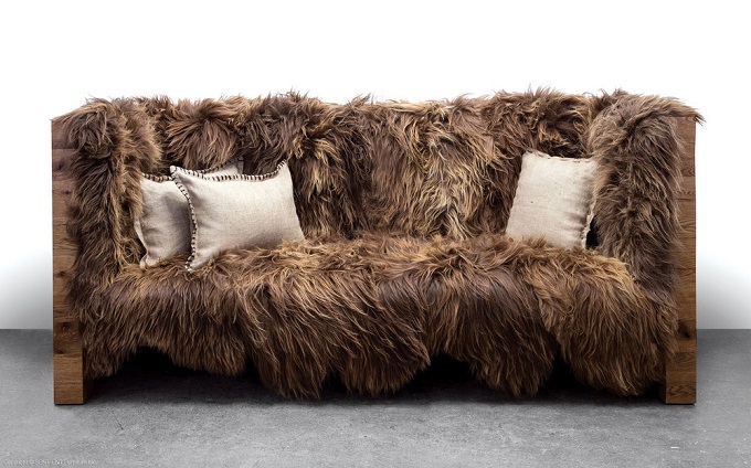 A unique sofa with fur on it.