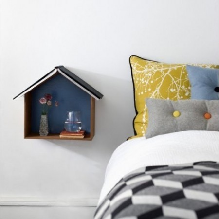 A bed with a bird house and nightstands on the wall.