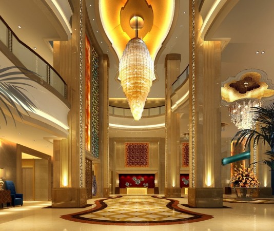 A luxury hotel with a large chandelier showcases interior design.