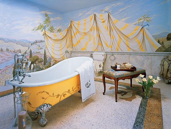 A bathtub with a mural on the wall, exuding elegance and charm.