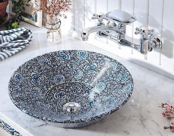 A blue and white floral-patterned vessel sink to beautify your bathroom.