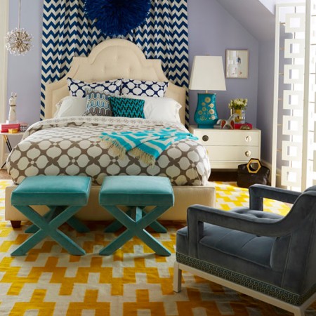 A graphic blue and yellow bedroom with a chevron pattern.