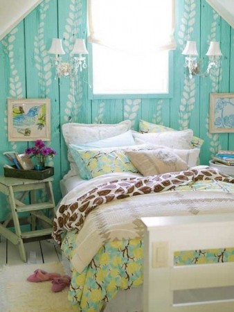 A bedroom with blue and green walls, a bed, and nightstands.