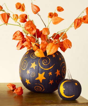 A custom carved pumpkin decorated with flowers.