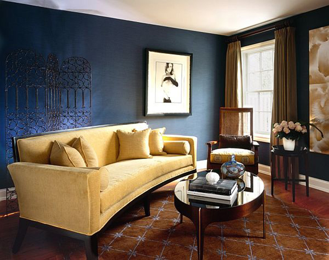 A living room with blue walls and a yellow couch, featuring an elegant brown and blue interior color scheme.