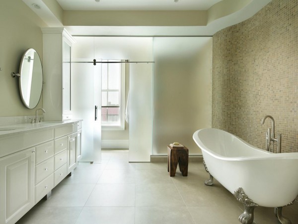 A white bathroom with a bathtub and sink exudes the elegance and charm of a clawfoot bathtub.