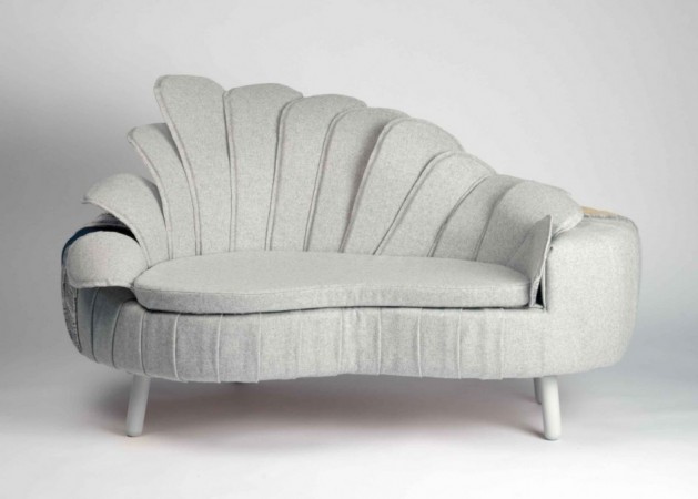 A unique sofa with a wing-shaped seat.