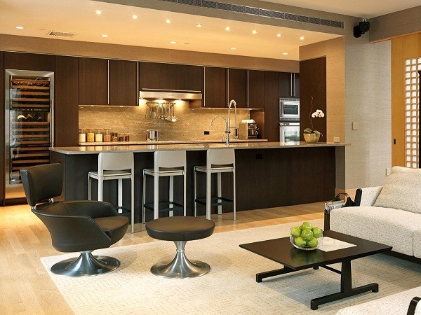 A modern living room with an open kitchen and dining area.
