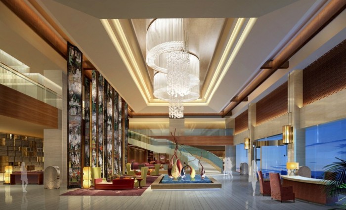 A hotel lobby with an impressive chandelier showcases interior design.