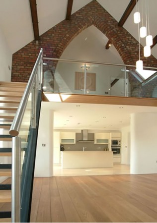 A wooden staircase in a restored church-turned-family home.
