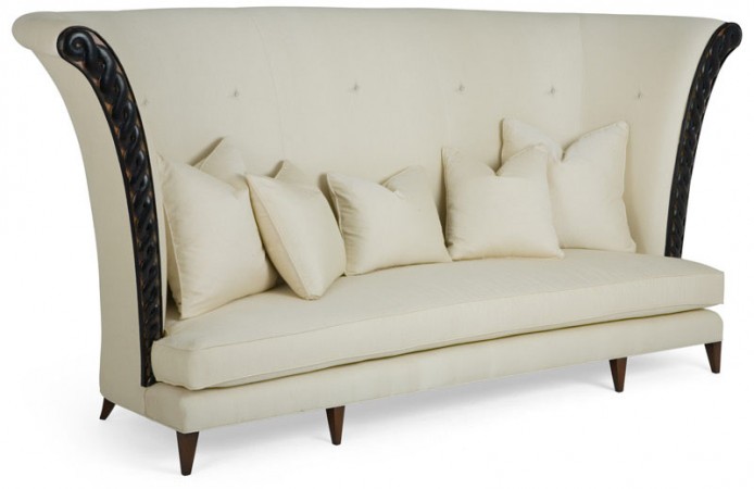 A unique wingback sofa adorned with inviting pillows.