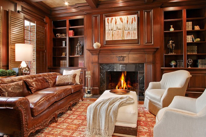 A living room with a fireplace and leather furniture showcasing the allure of leather seating.