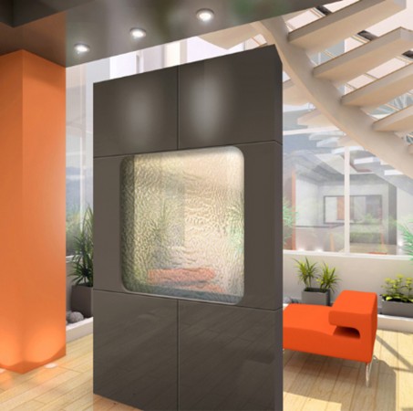 An orange couch sits in a room with water walls.