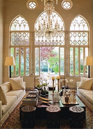 Styling a living room with ornate windows and a chandelier.