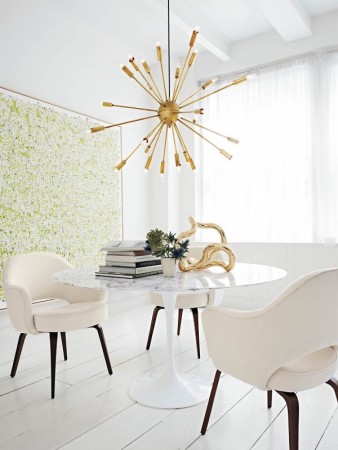 A Mid-Century Modern style dining room with a white table and chairs.