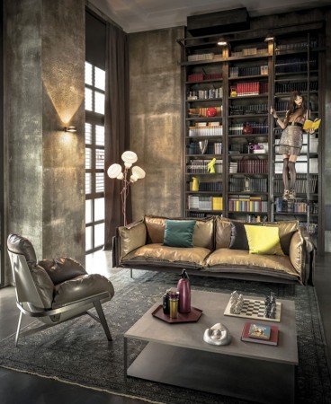 A living room with bookshelves and leather seating.