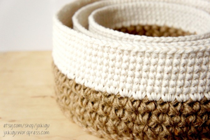 Three crocheted baskets on top of a wooden table for a softer touch.