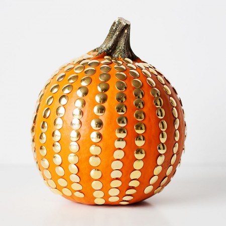 Michaels Custom Carved Pumpkins with gold polka dots on them.