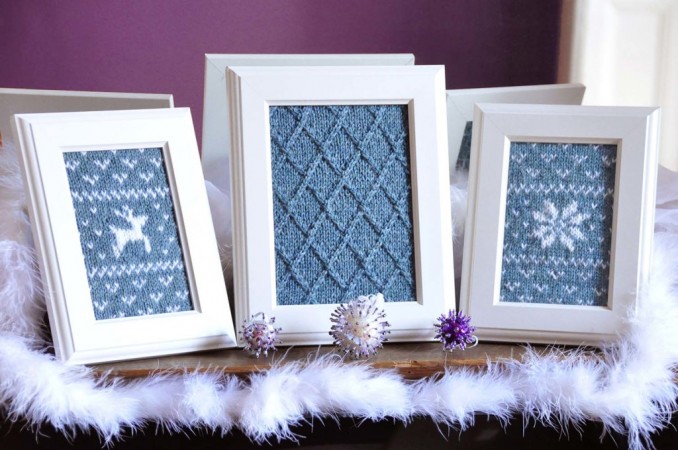 Three framed pictures with blue and white knitted ornaments, adding a softer touch to home décor.