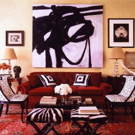 A bold red couch brings graphic intensity to a living room.