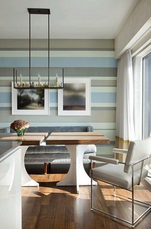 Horizontally striped wallpaper of varying widths gives interest to this room