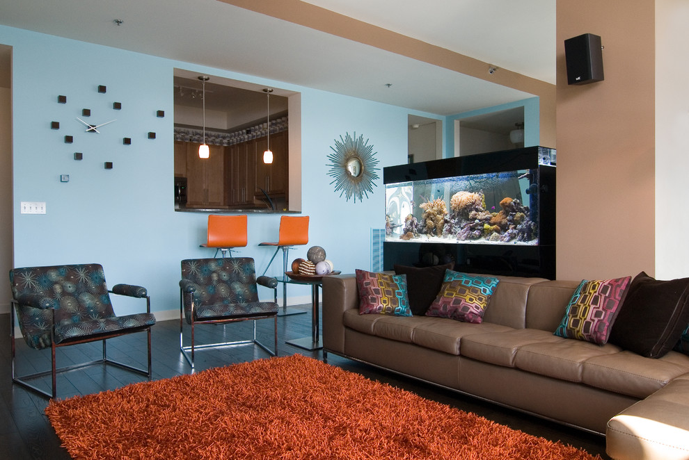 A living room with a fish tank featuring an elegant brown and blue interior color scheme.