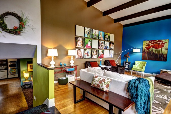 A living room with an art-inspired interior design featuring many pictures on the wall.