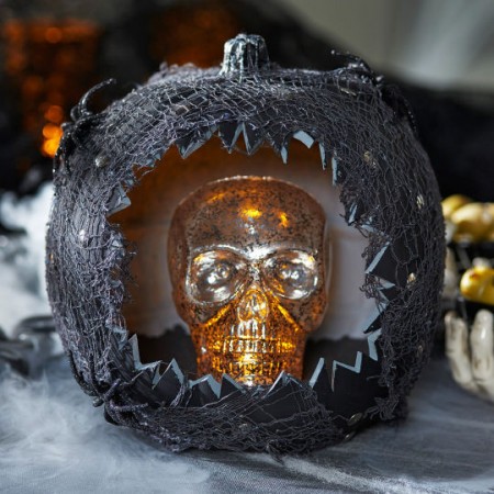 A custom-carved Halloween pumpkin featuring a skull at Michaels.