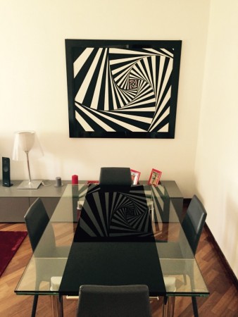 A dining room with optical art.
