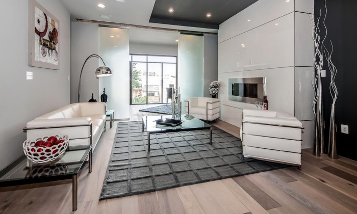 Keywords: Modern living room, black walls, white furniture, leather seating.