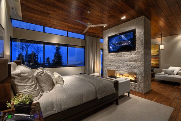 contemporary bedroom with a stunning fireplace