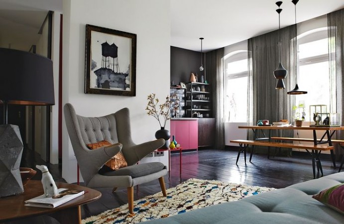 A Mid-Century Modern style living room with black and grey walls and furniture.