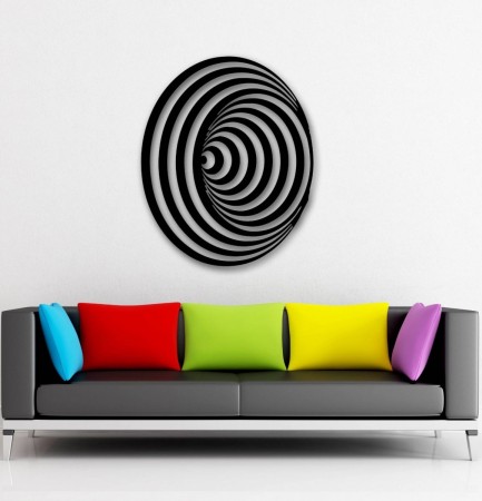 A couch with colorful pillows and a black and white spiral wall art inspired by optical art.