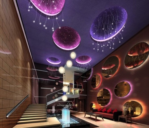 The lobby of a hotel is decorated with purple lights, teaching us about interior design.