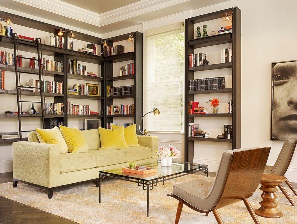 A living room with vertical bookshelves.