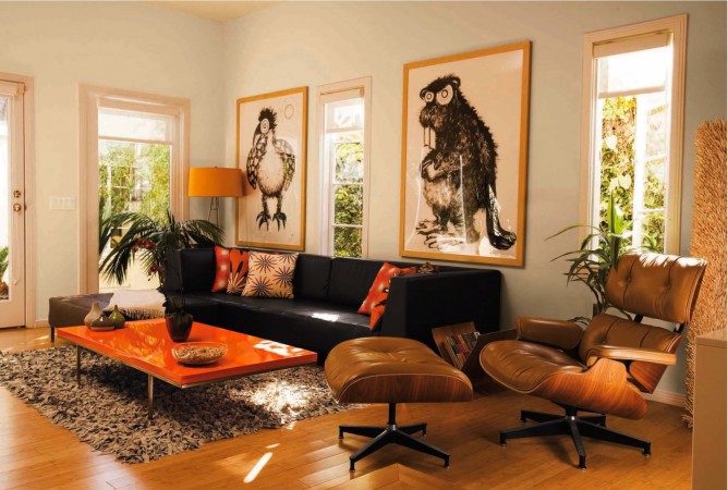 A living room with a black leather couch and orange coffee table showcasing the versatility of leather seating.