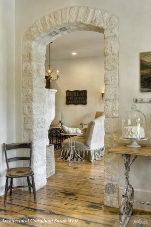 Keywords: Stone Walls, Inside Your Home

Updated Description: Stone walls create a captivating ambiance in the living room, through a stone archway.