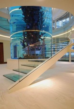 A glass staircase with an aquarium in the middle.