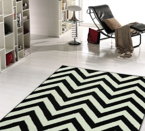 A black and white chevron rug featuring optical art in a living room.