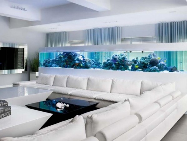 A living room with a prominent aquarium centerpiece.