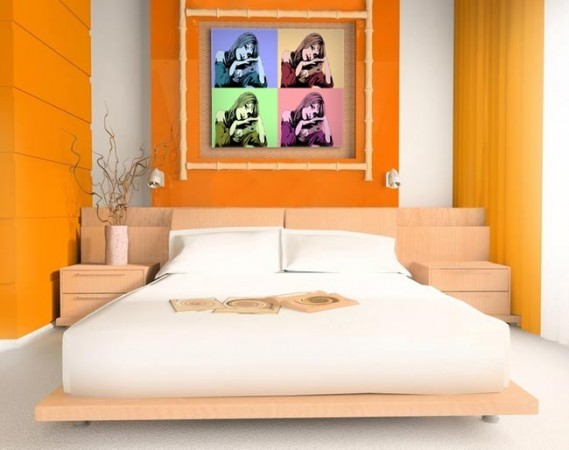 A pop art-inspired bedroom with orange walls and a white bed.