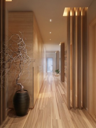 A hallway with wooden panels and a potted plant.