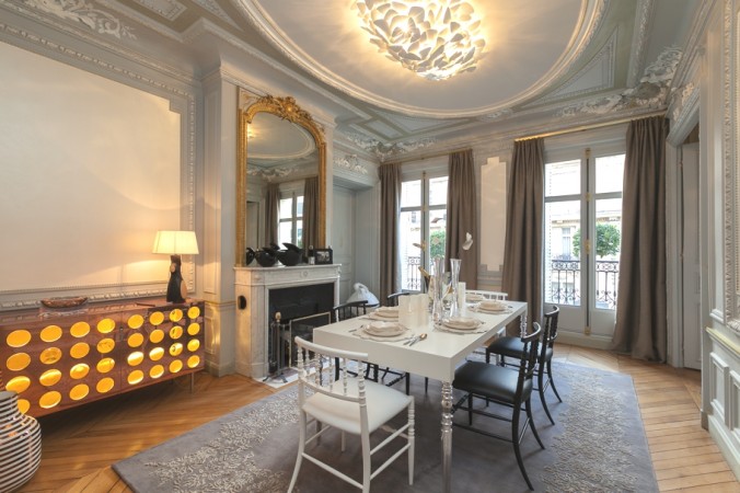A haute couture dining room featuring a chandelier and a dining table.