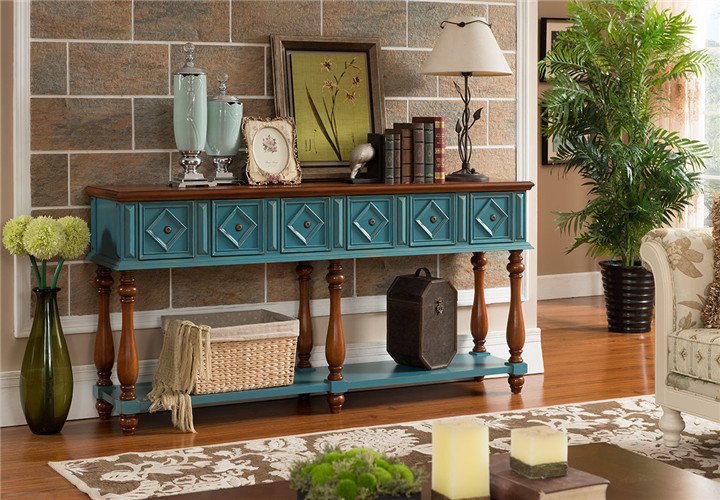 A blue console table given new life with paint in a living room.