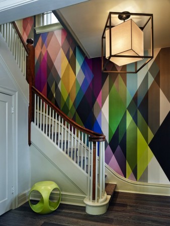 A colorful mural adorns a staircase in a creative design.