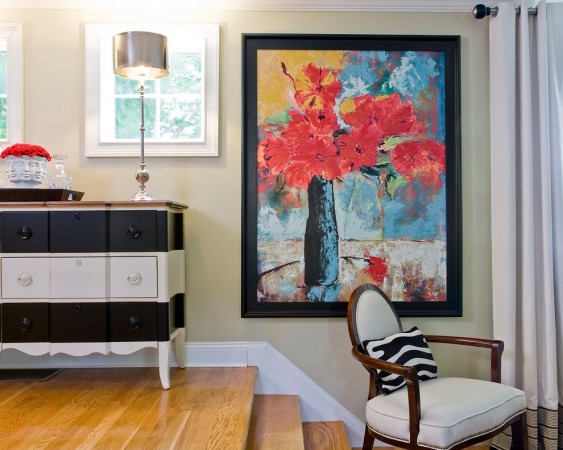 A painted framed painting in a living room.