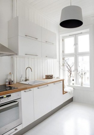 Lighten Up a Kitchen with Painted White Floorboards.