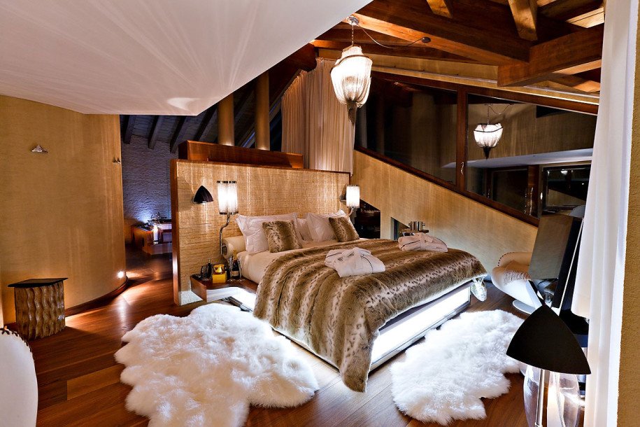 A cozy bedroom with a large bed and fur rug to warm up your winter.