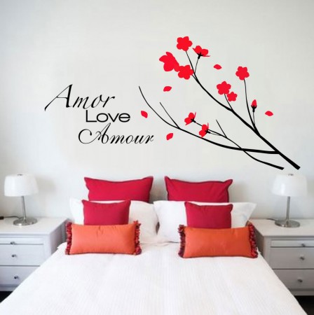 A bedroom with a bed and a wall decal featuring annie love annie.